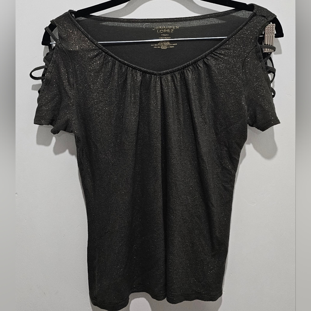 JL green shirt with gold glitter.